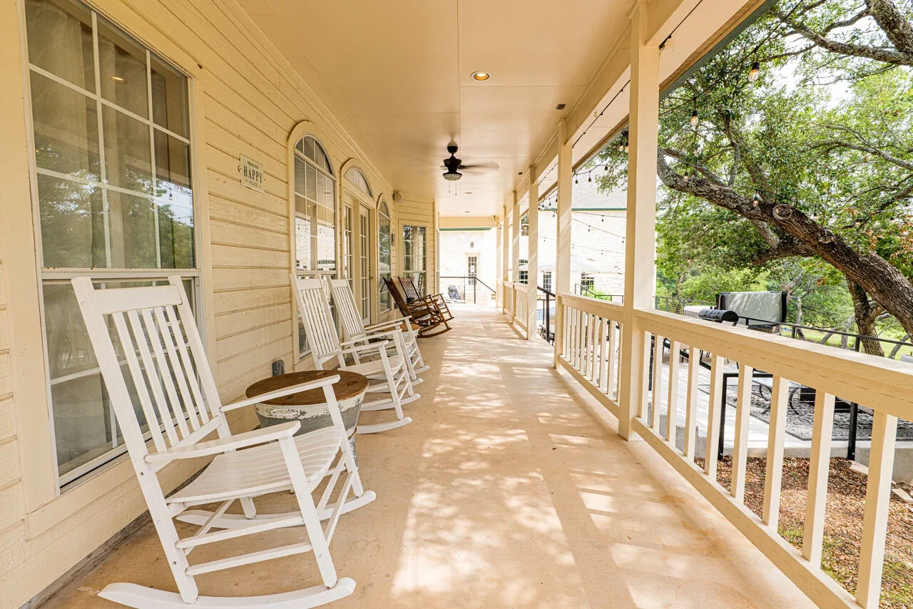 Long covered porch with rocking chairs
