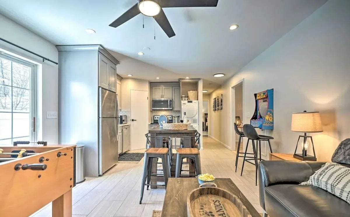 Poconos lower-level gathering space with foosball, kitchen, arcade game, and seating
