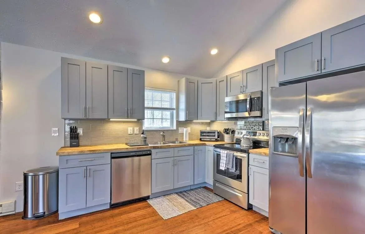 Poconos remodeled kitchen with gray cabinetry, stainless appliances, and wood counters