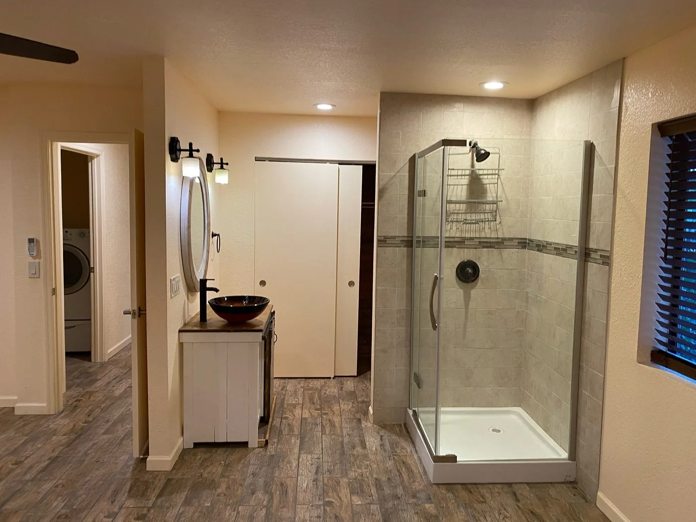 Sedona primary bath before renovation: dated vanity with vessel sink and cramped corner shower